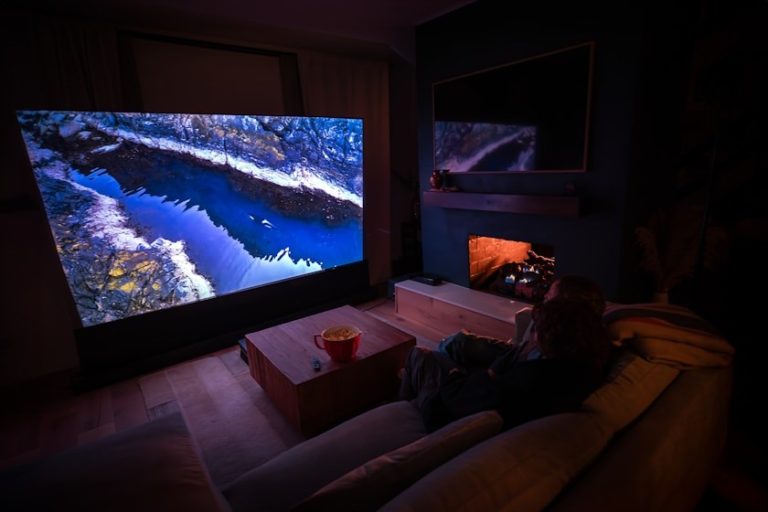 Domácí kino s&nbsp;velkou projekční plochou a reproduktory v&nbsp;obývacím pokoji